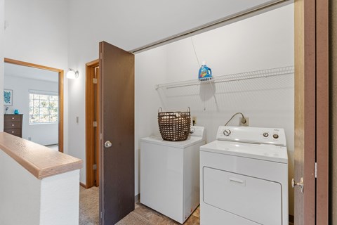 A small laundry room with a washer and dryer.