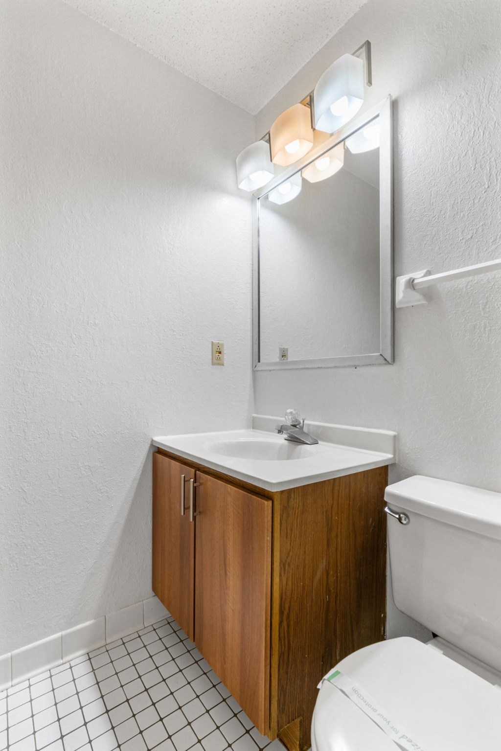 a bathroom with a toilet and a sink and a mirror