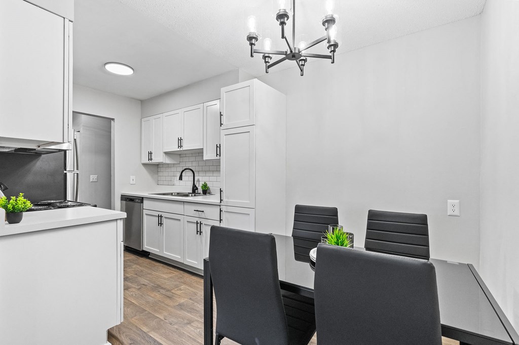 a dining room and kitchen with a table and chairs