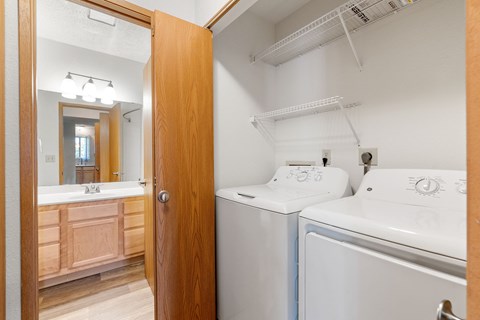 A white washer and dryer in a small laundry room.