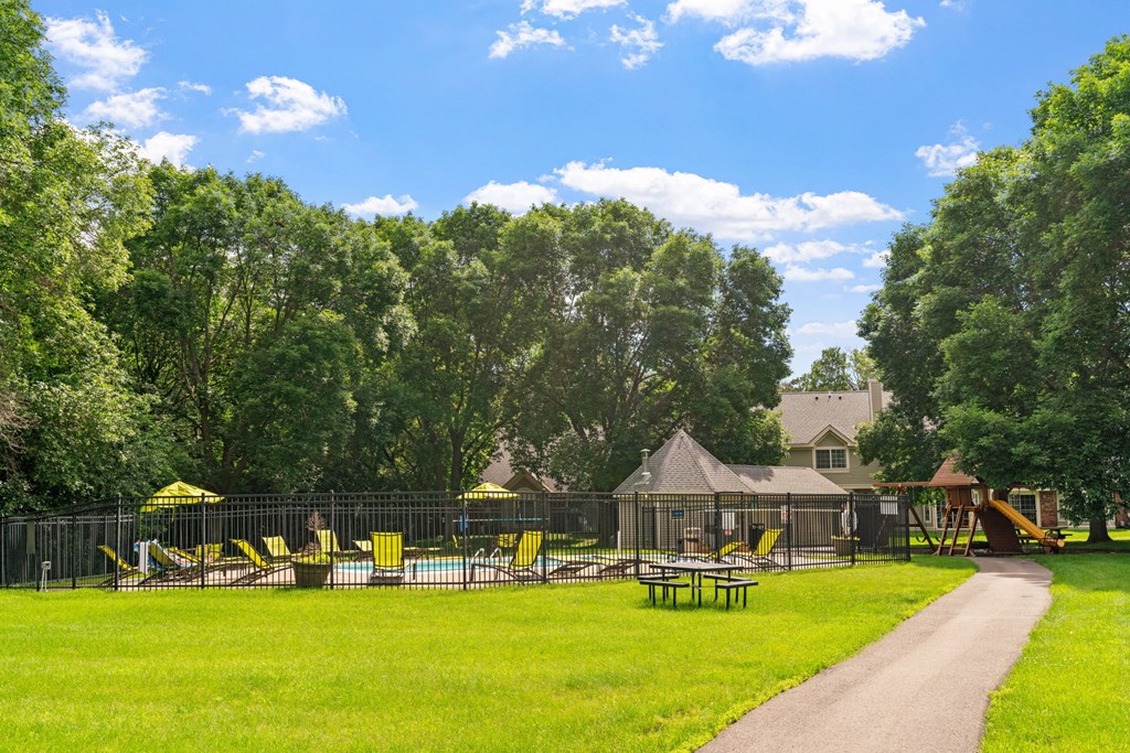 A playground with a slide and a swing set.