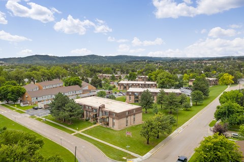 A view of a street with cars and buildings.