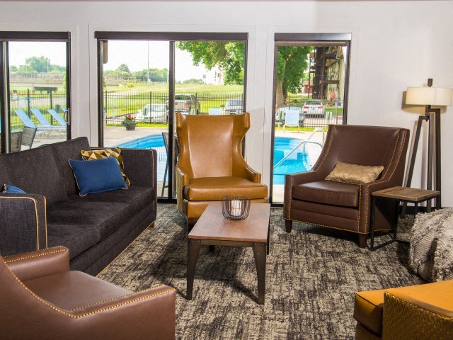a living room with a couch and chairs and a pool