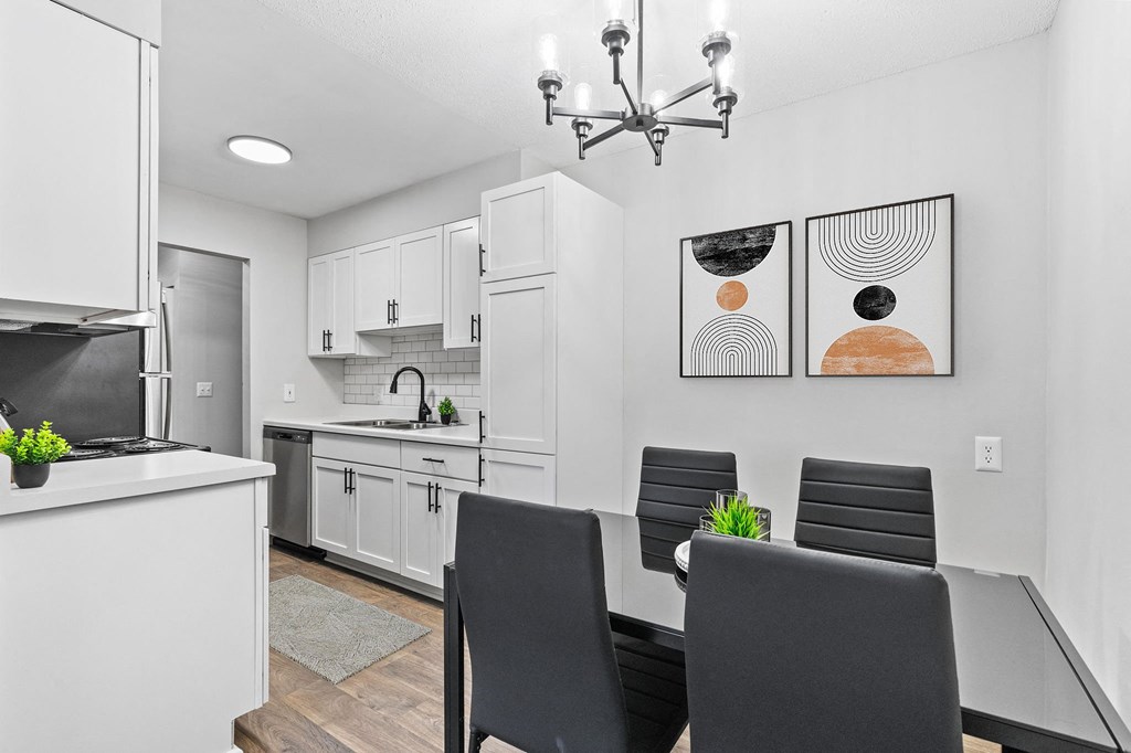 a kitchen and dining room with a table and chairs