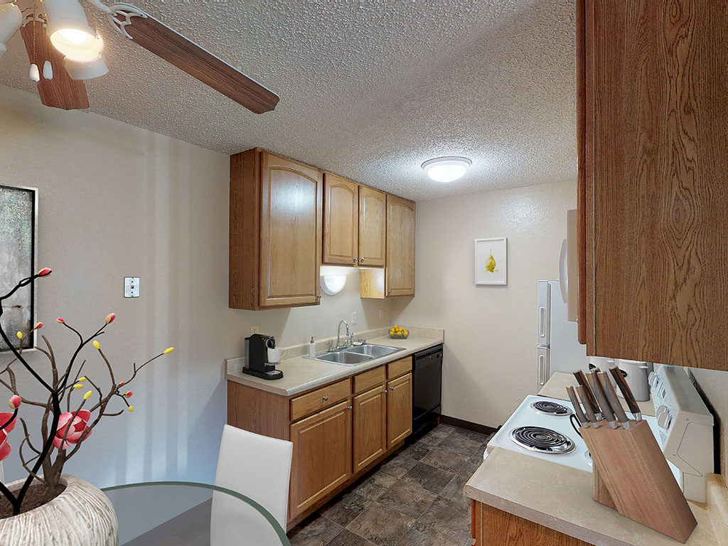 A kitchen with wooden cabinets and a white countertop.