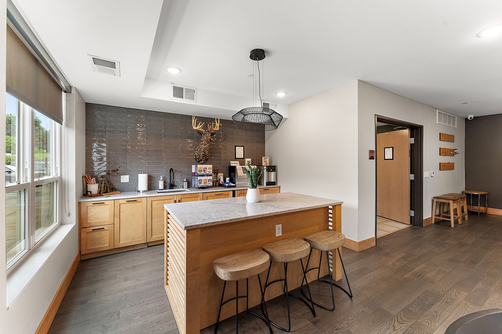 A kitchen with a bar stool and a counter.