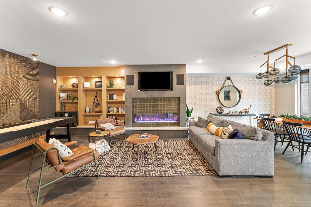 A modern living room with a fireplace and a television.