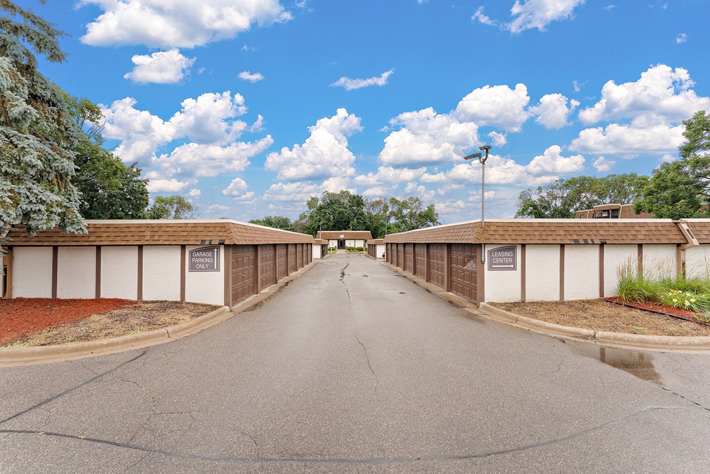 A long road with a white line in the middle and a sign on the right side.
