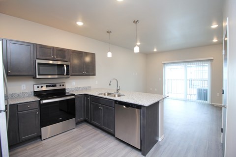 A kitchen with dark brown cabinets and stainless steel appliances.