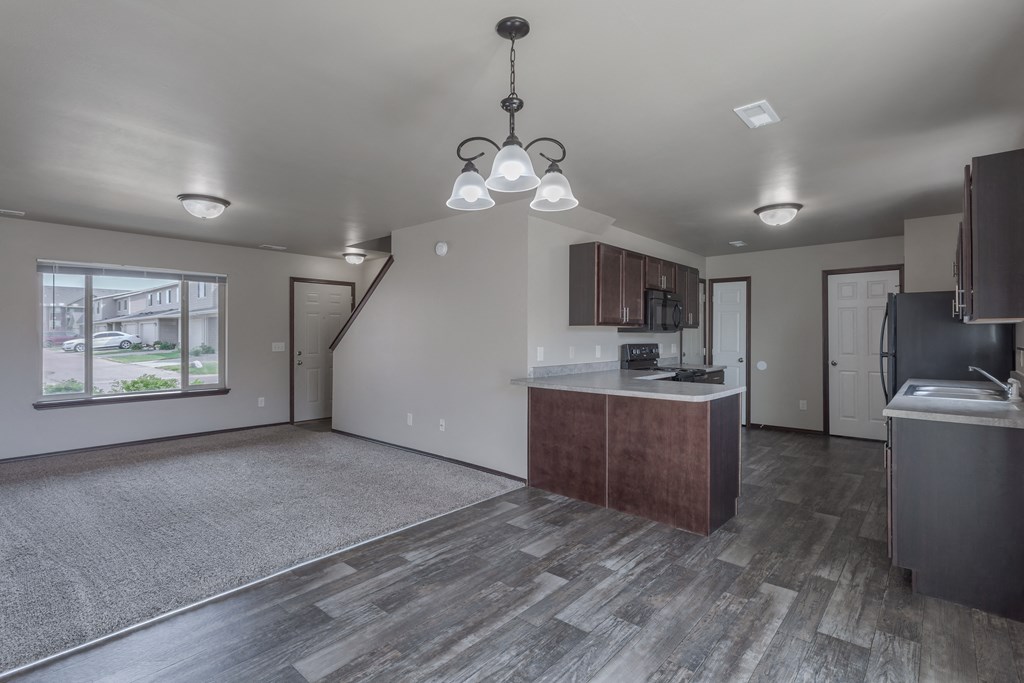an open kitchen and living room with a large window