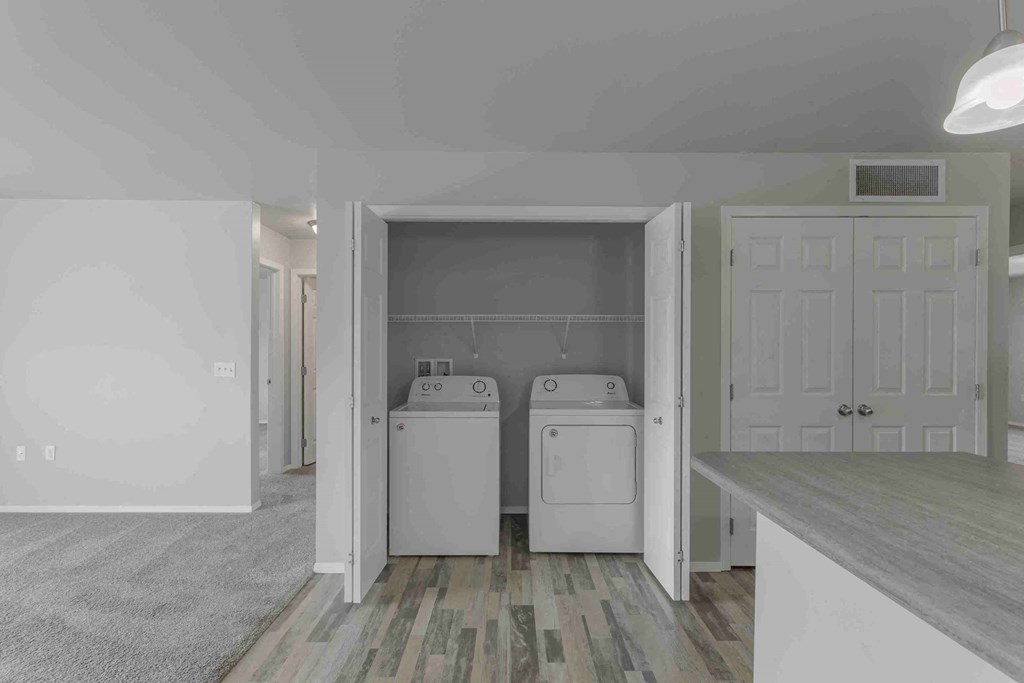 a laundry room with two washes and a dryer