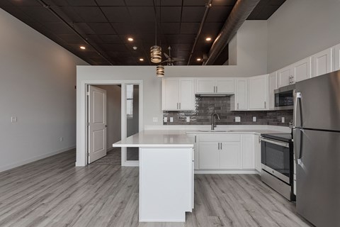 a kitchen with white cabinets and a white counter top