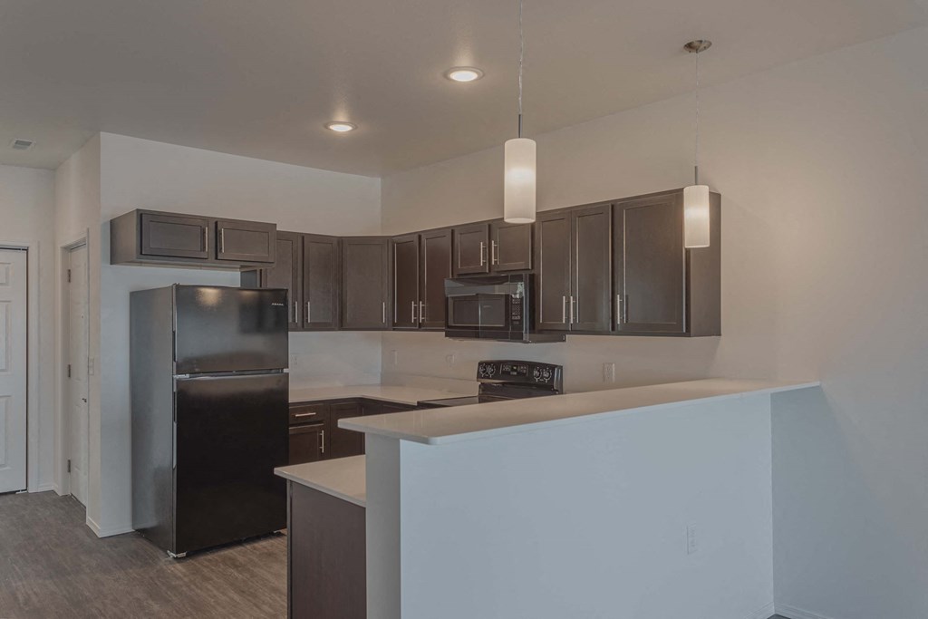 a kitchen with a counter top and a refrigerator