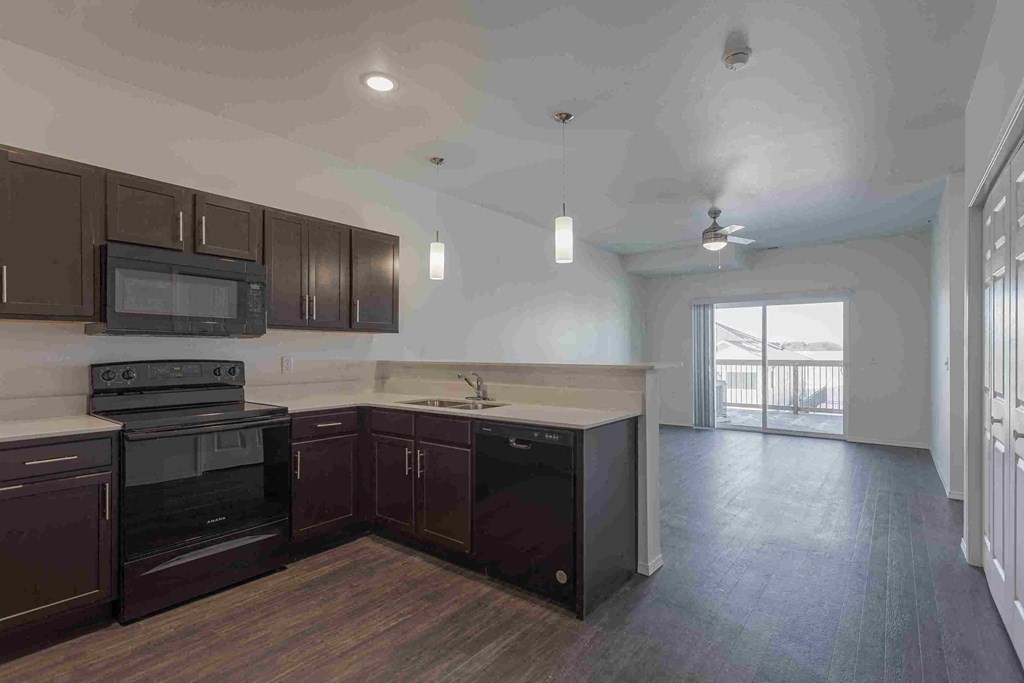 an empty kitchen with a stove and a sink