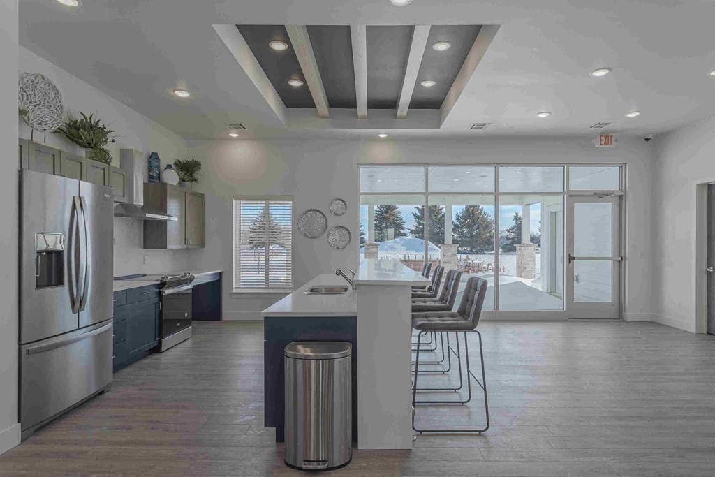 a kitchen with stainless steel appliances and a table with chairs
