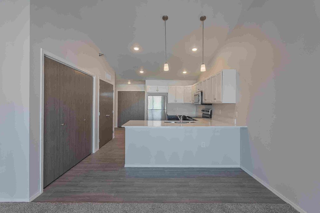 a kitchen with white cabinets and a white counter top