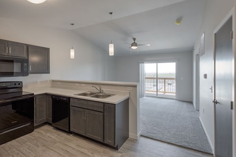 A kitchen with a sink, stove, and oven.