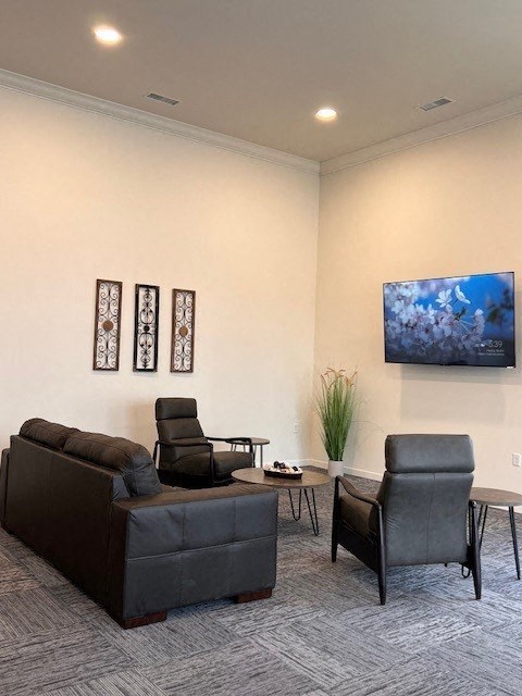 a living room with a couch and two chairs