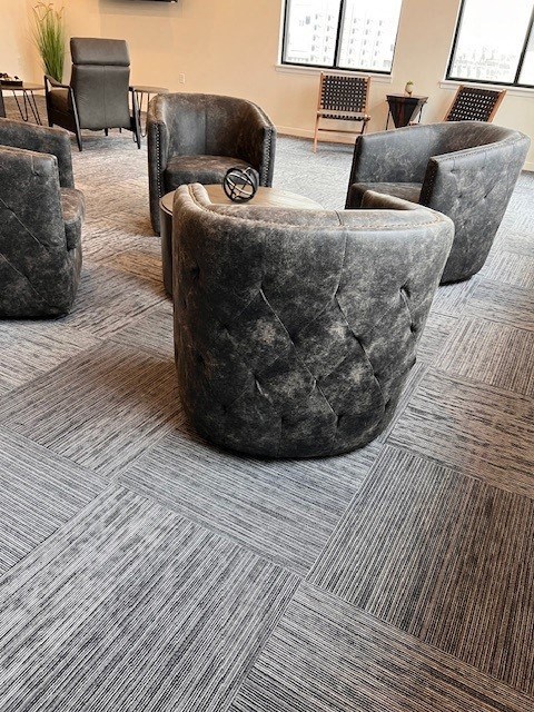 a group of chairs sitting around a table in a room