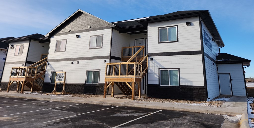 A row of houses with a sign that says "For Sale".