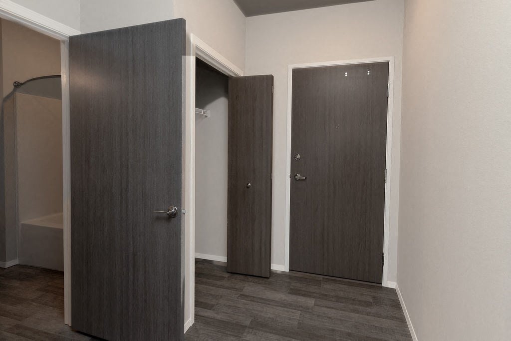 a room with three doors and a closet