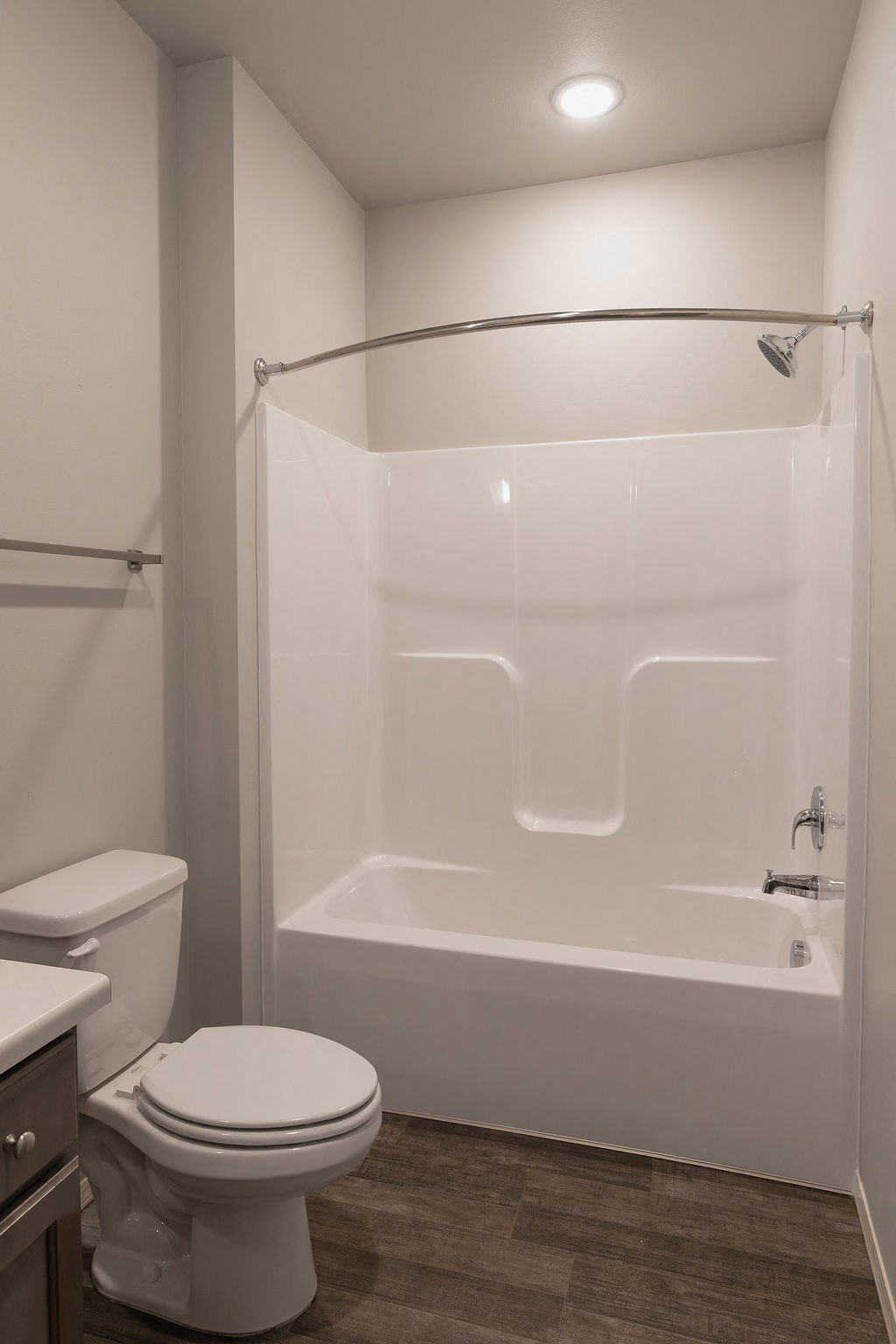 a bathroom with a shower and a toilet and a sink