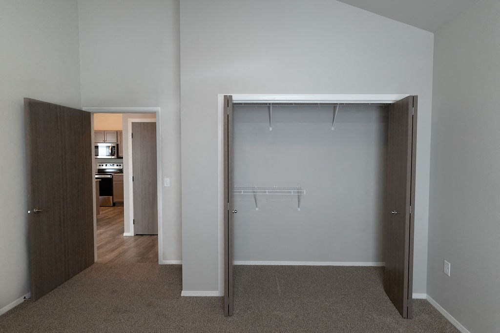 a bedroom with a closet and a door to a bathroom