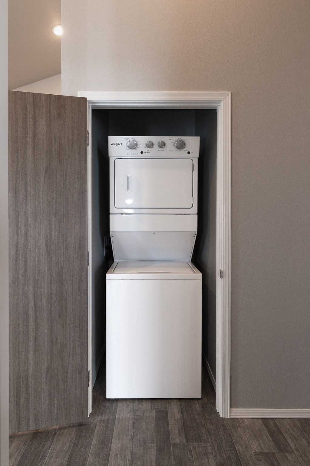 an empty closet with a washer and dryer in it
