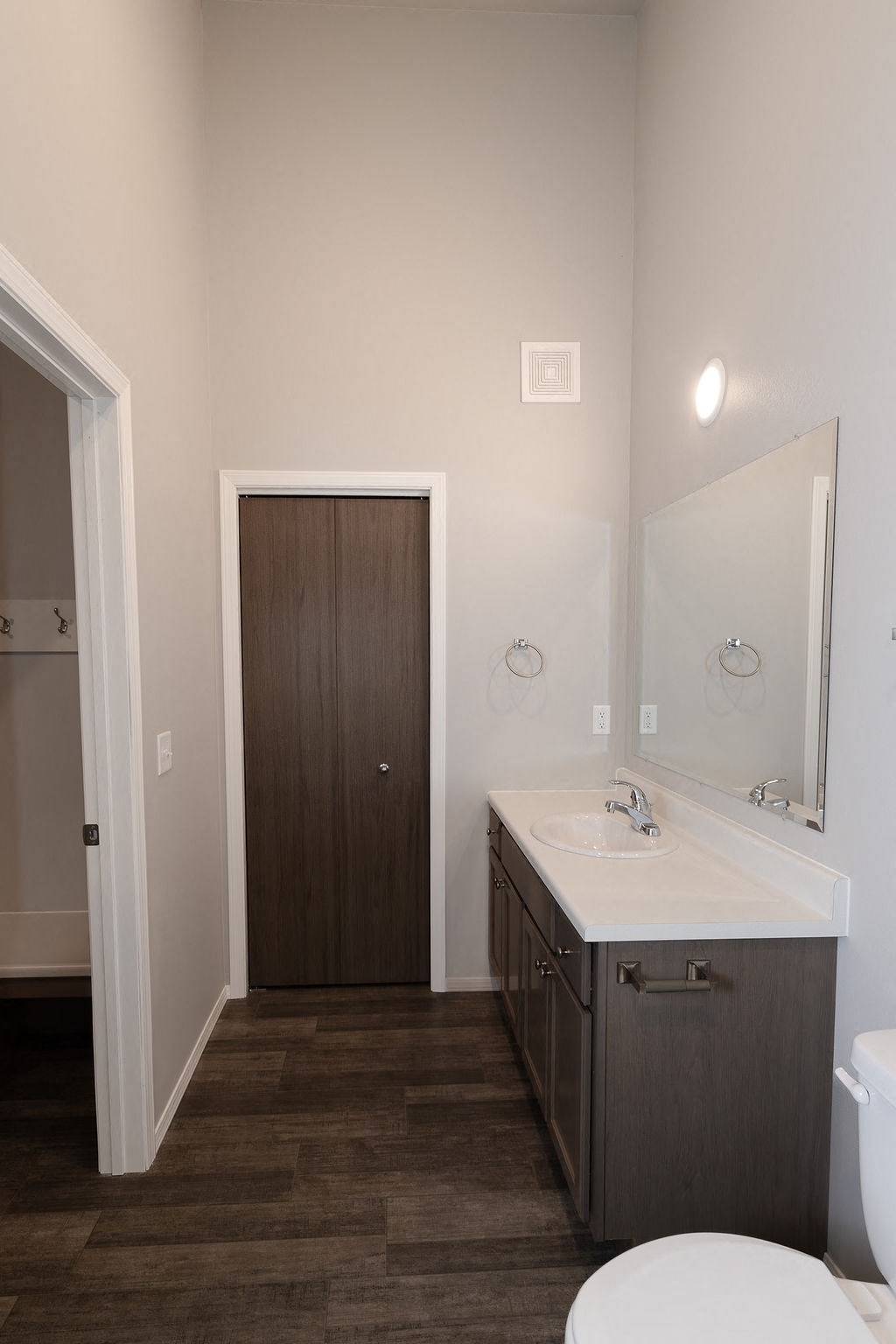 a bathroom with a toilet sink and a mirror