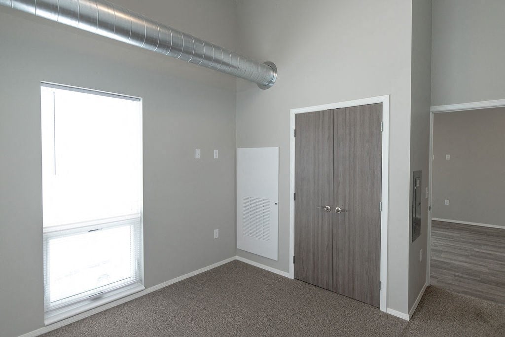 an empty room with a door and a window