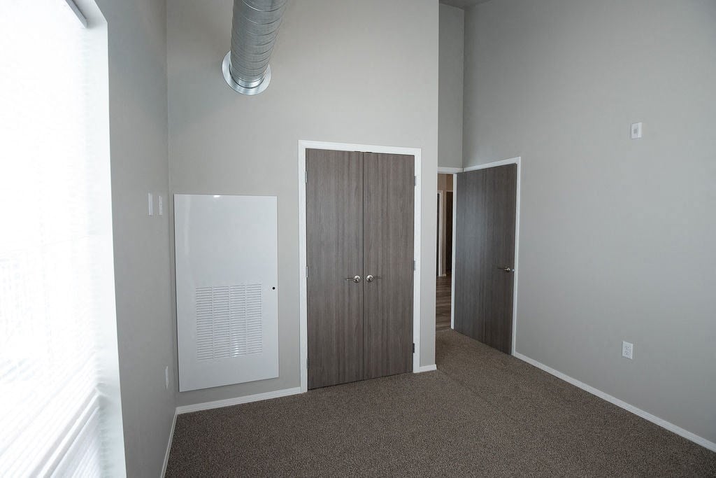 a bedroom with a door and a closet