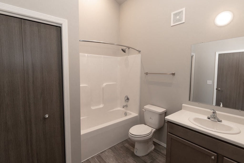 a bathroom with a shower toilet and sink