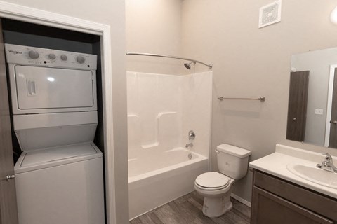 a bathroom with a tub and a sink and a toilet