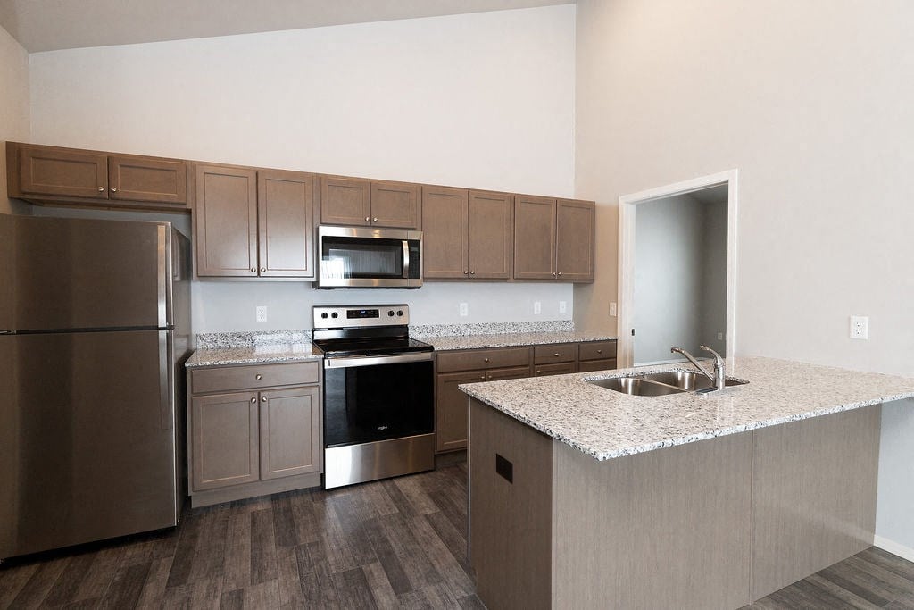 a kitchen with stainless steel appliances and granite counter tops