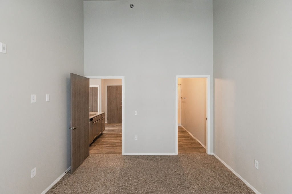 a bedroom with a closet and a door to a bathroom