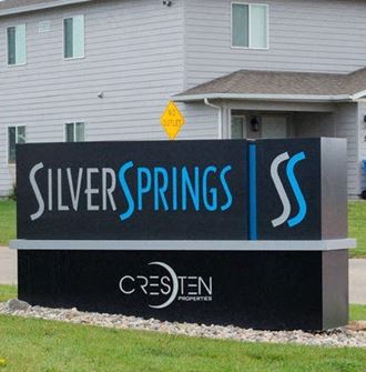 a sign for silver springs in front of a house