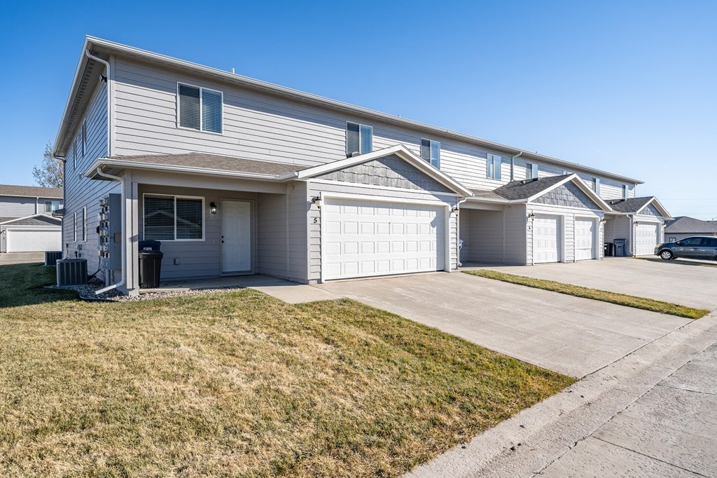 a white house with a driveway and a garage door