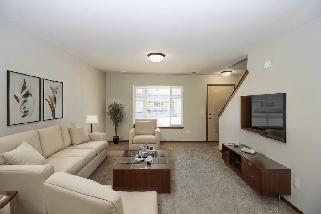A living room with a couch, chair, and coffee table.