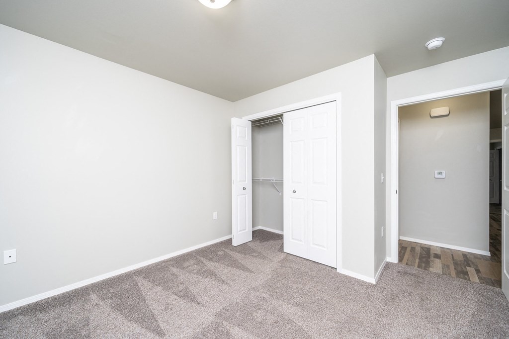 a empty room with a closet and a door to a closet