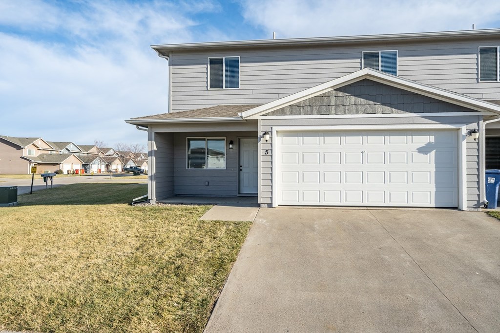 a house with a white garage door and a driveway