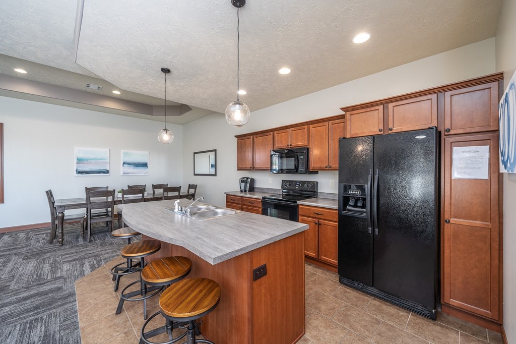a kitchen with a island and a table with chairs