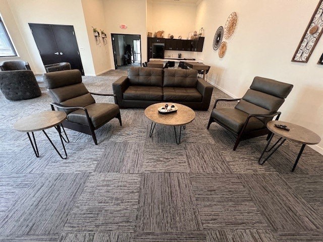 a living room with couches chairs and tables