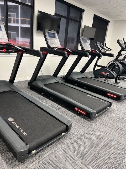 a row of exercise bikes in a gym