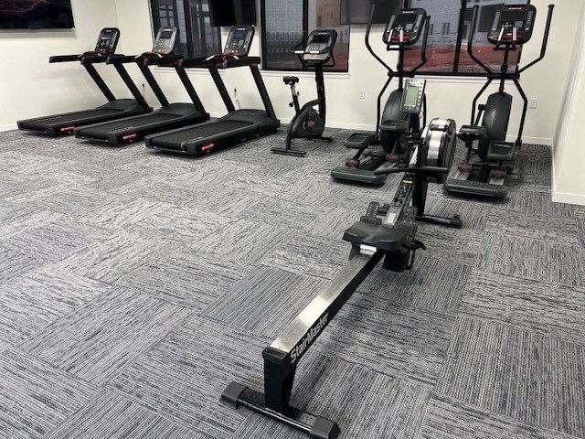 an image of a gym with weights on the floor