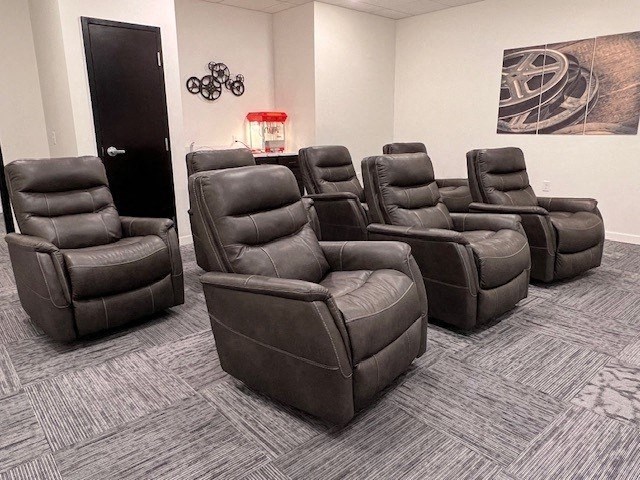 a group of brown reclining chairs in a room