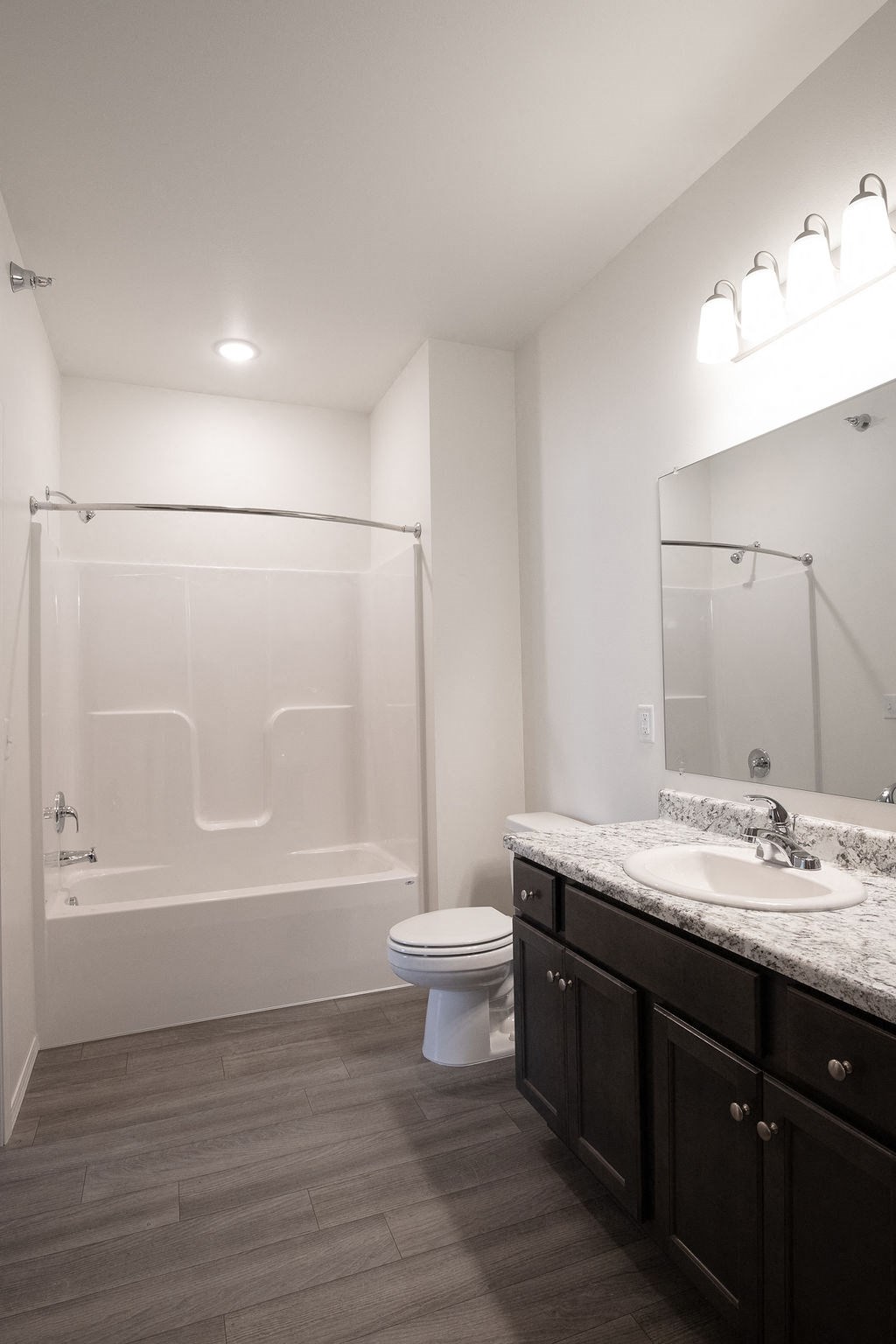 a bathroom with a shower and a sink and a toilet