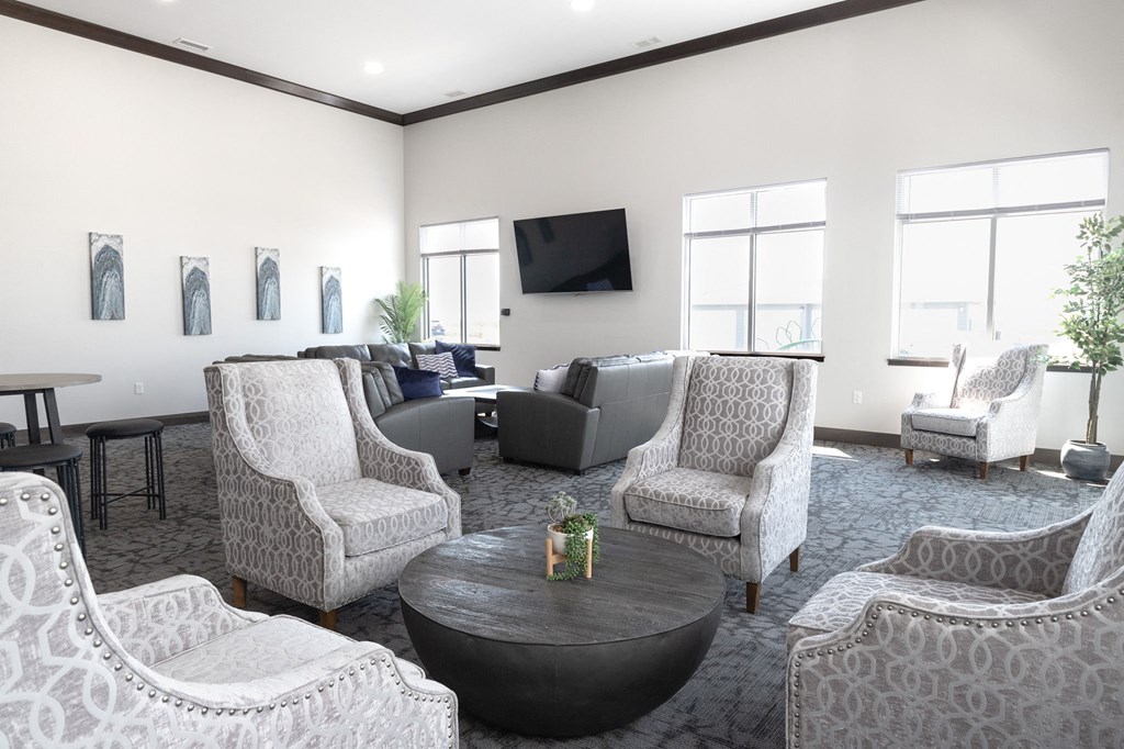 a resident clubhouse with couches chairs and a coffee table