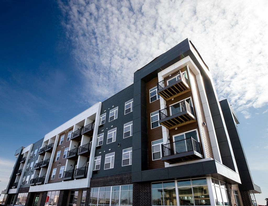 A modern building with balconies and large windows.