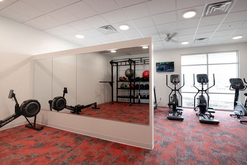 fitness room with mirror