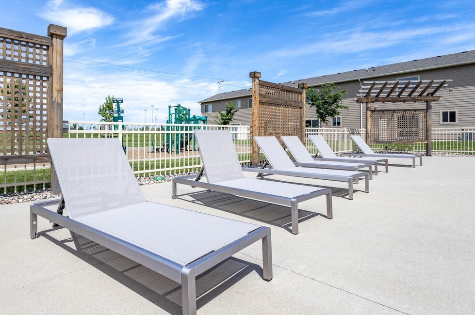 a row of lounge chairs in front of a building